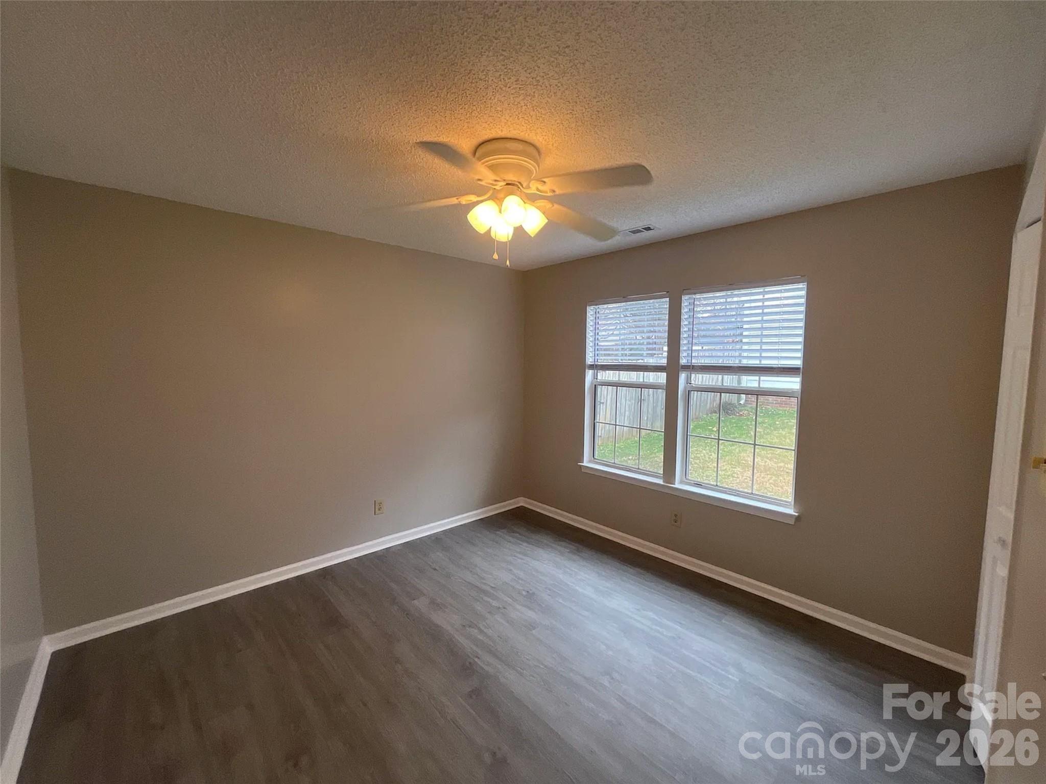 12042 Mallard Ridge Drive Charlotte, NC 28269 - Photo 15 of 20 wooden floor in an empty room with a window