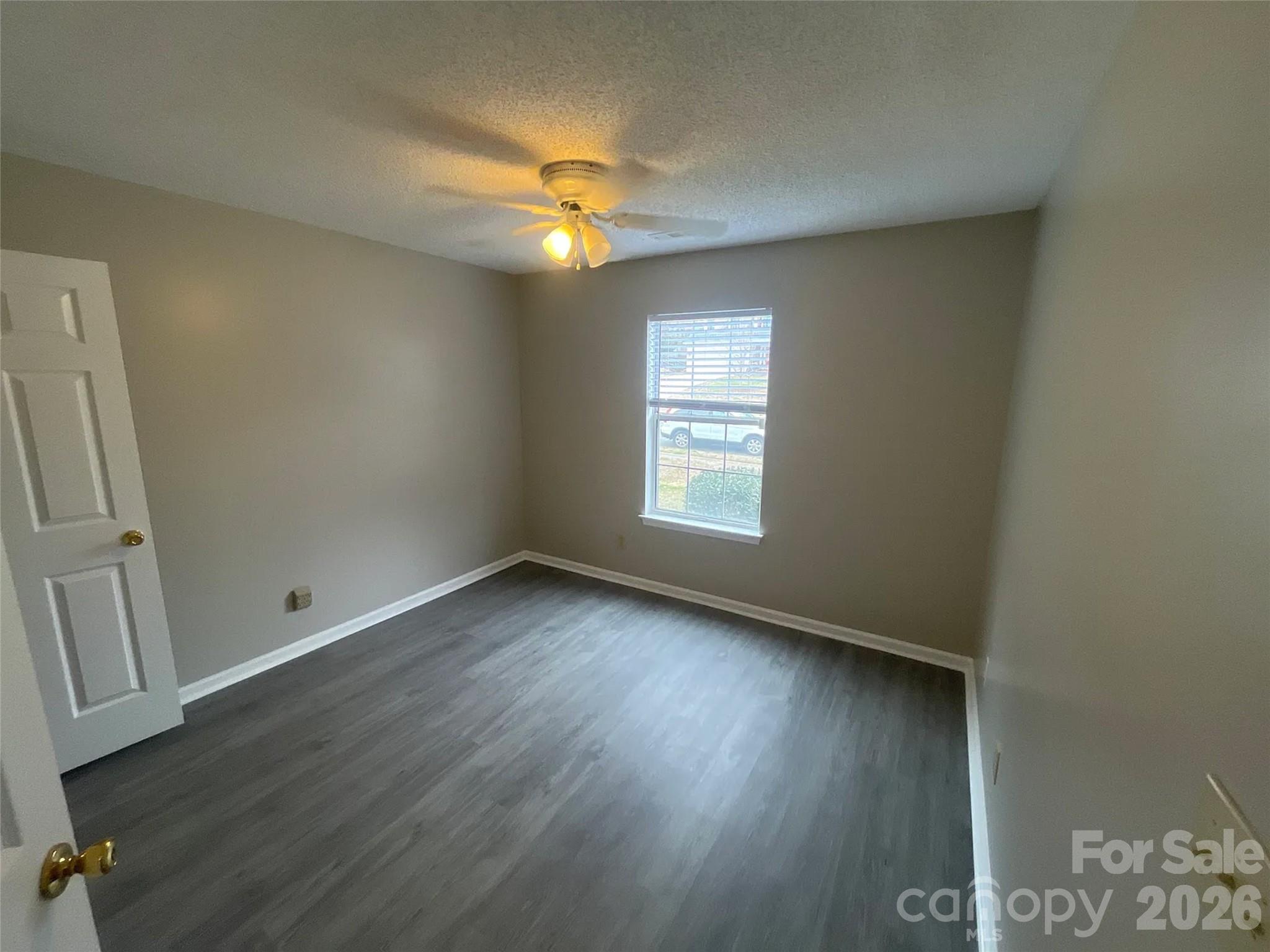 12042 Mallard Ridge Drive Charlotte, NC 28269 - Photo 16 of 20 an empty room with wooden floor and windows