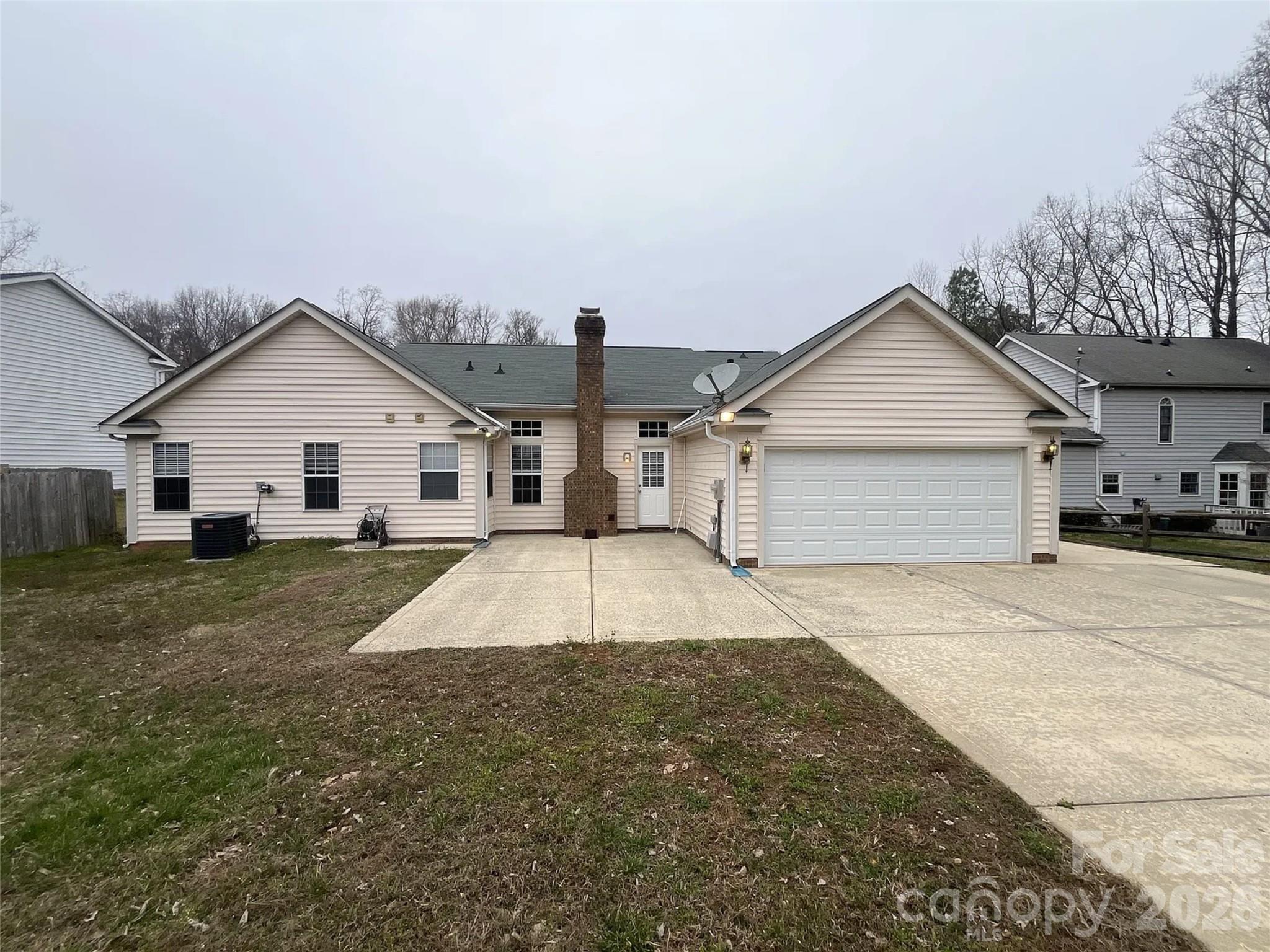 12042 Mallard Ridge Drive Charlotte, NC 28269 - Photo 19 of 20 a view of a white house with a yard and garage