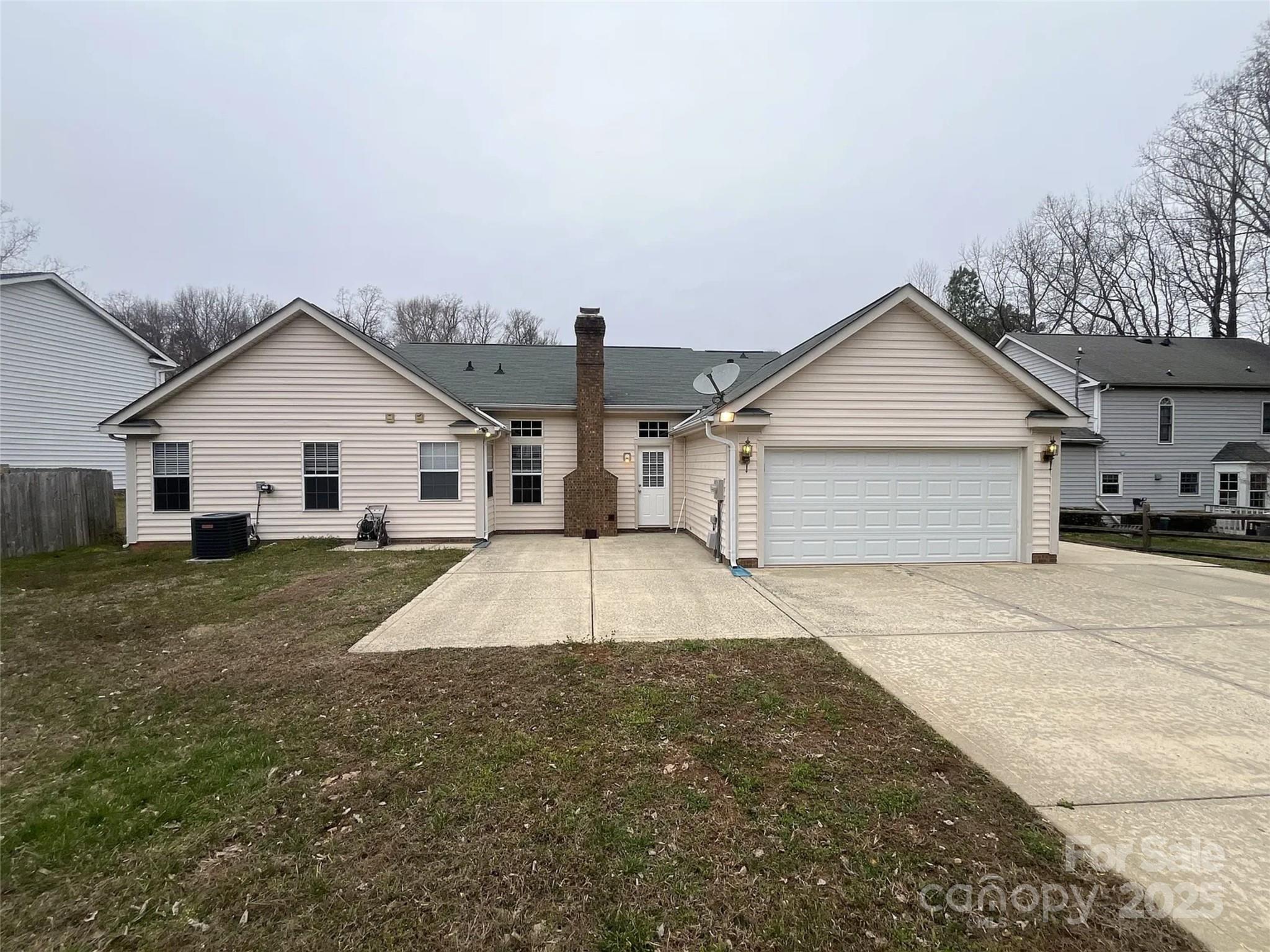 12042 Mallard Ridge Drive Charlotte, NC 28269 - Photo 19 of 19 a view of a white house with a yard and garage