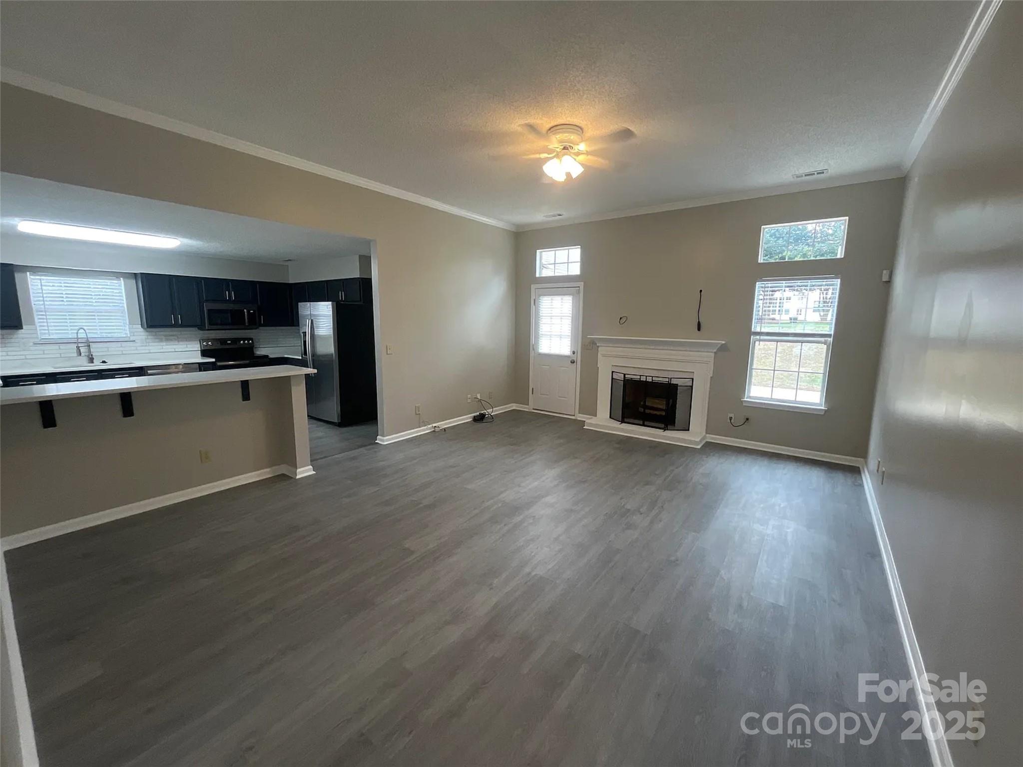 12042 Mallard Ridge Drive Charlotte, NC 28269 - Photo 2 of 19 a view of a kitchen with a sink stove cabinets and empty room