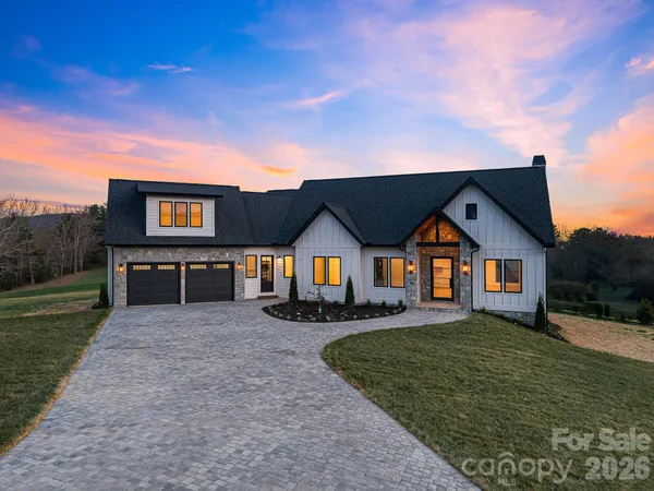 a living room with a fireplace and a floor to ceiling window