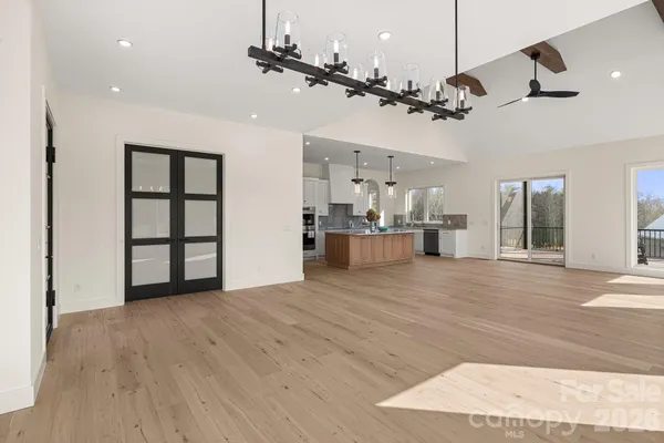 a kitchen with granite countertop white cabinets stainless steel appliances and a counter space