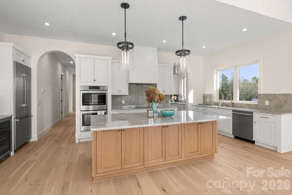a kitchen with granite countertop white cabinets and sink