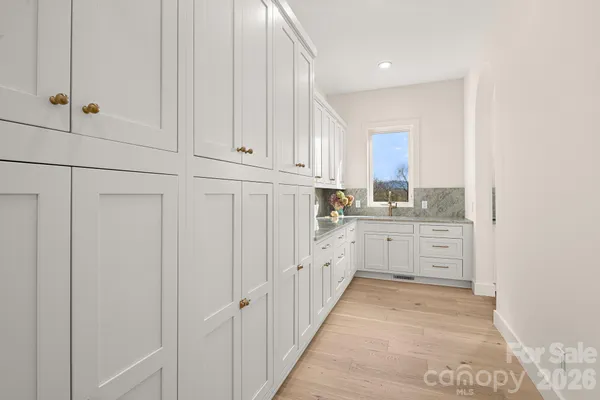 an empty room with wooden floor and closet