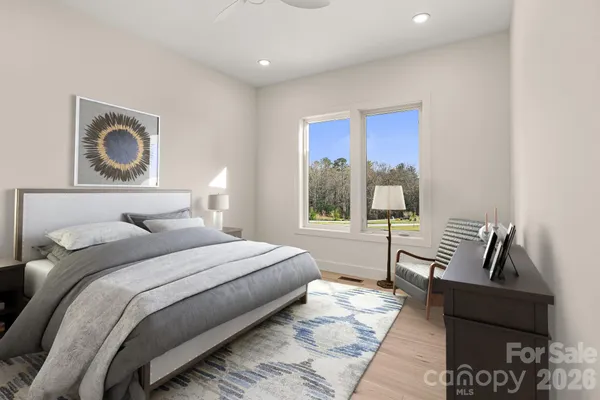 a kitchen with white cabinets and sink