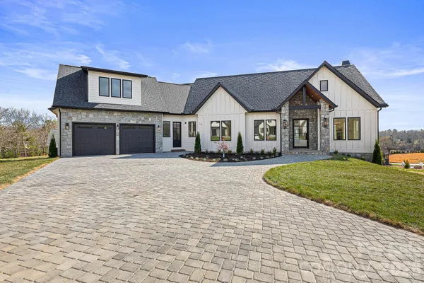 a kitchen with white cabinets appliances and sink