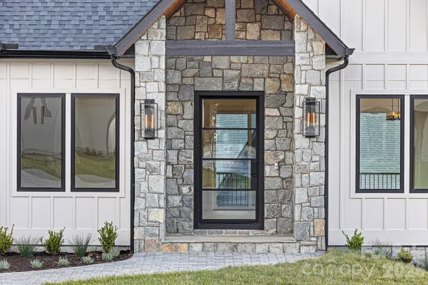a kitchen with stainless steel appliances granite countertop a sink refrigerator and cabinets