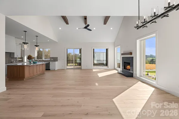 a open kitchen with granite countertop a large window and a sink