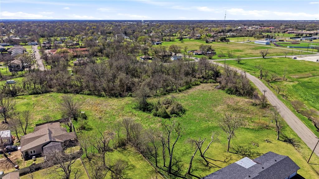 1700 Agnew Street Bonham, TX 75418 - Photo 12 of 14 a view of a city with lush green forest