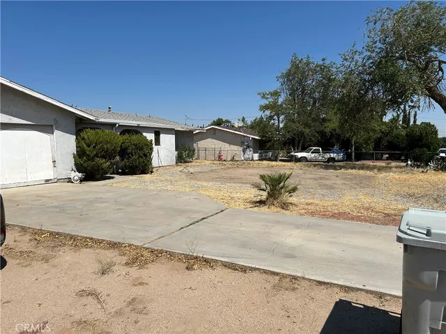 a view of a house with snow on the road