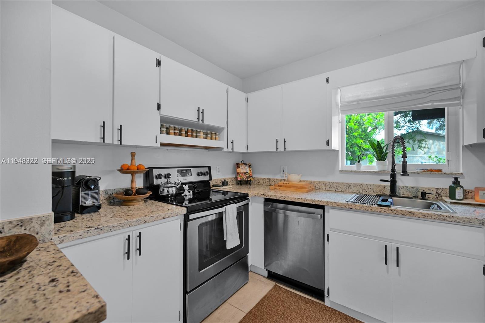 8780 Southwest 200th Terrace Cutler Bay, FL 33189 - Photo 13 of 39 a kitchen with stainless steel appliances granite countertop a sink stove and cabinets