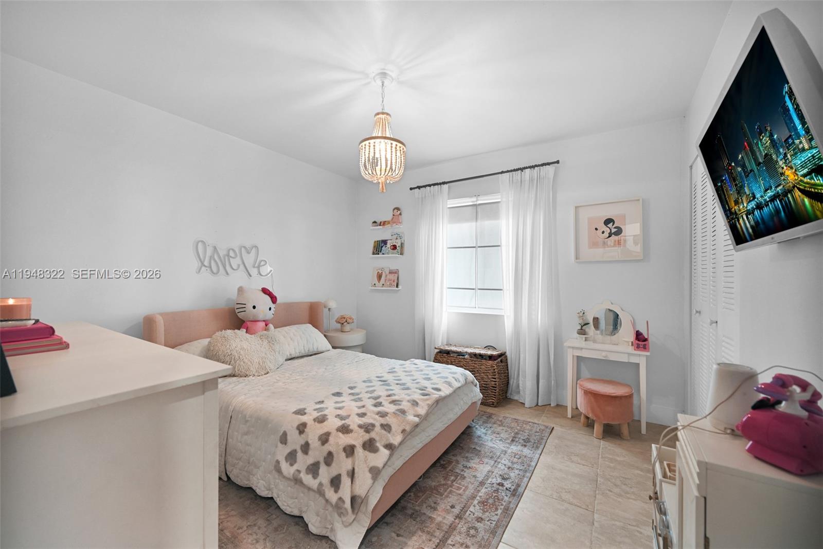 8780 Southwest 200th Terrace Cutler Bay, FL 33189 - Photo 18 of 39 a bedroom with a bed and a flat screen tv