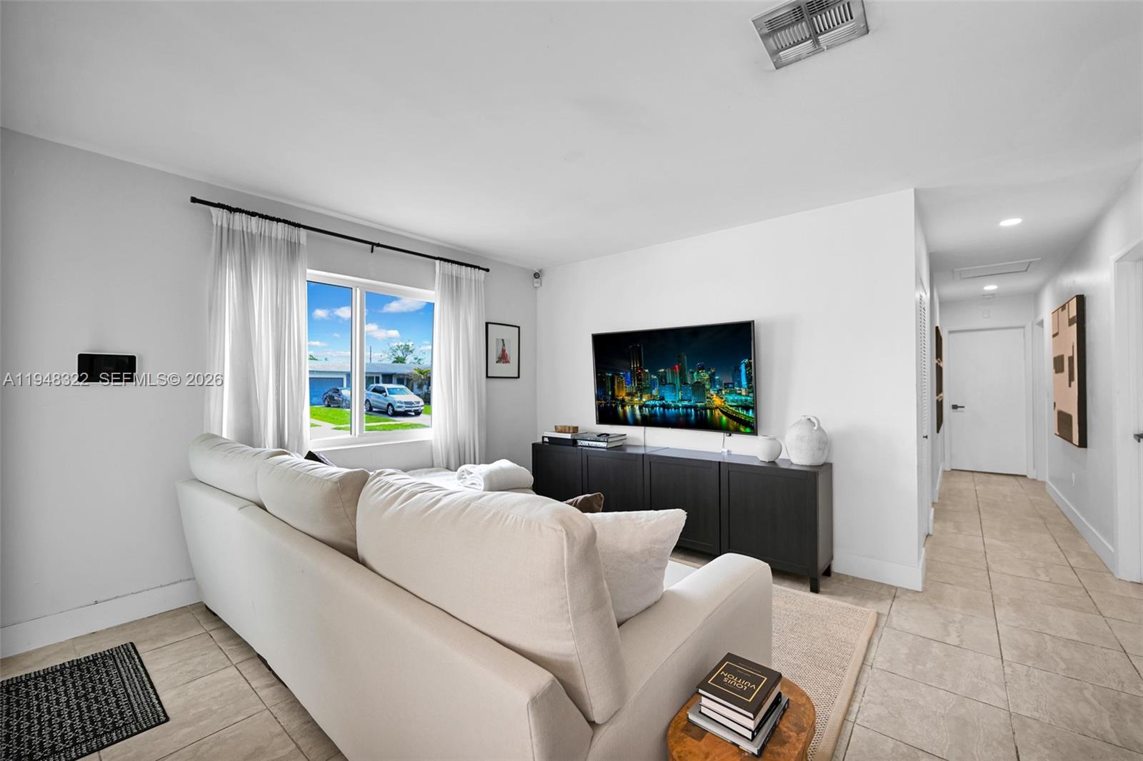 8780 Southwest 200th Terrace Cutler Bay, FL 33189 - Photo 2 of 39 a living room with furniture and a flat screen tv