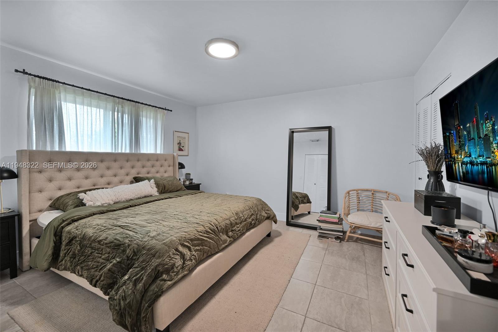 8780 Southwest 200th Terrace Cutler Bay, FL 33189 - Photo 23 of 39 a bedroom with a bed and a flat screen tv