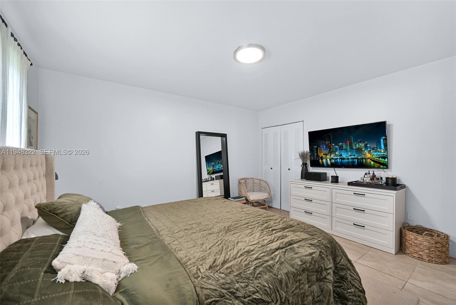 8780 Southwest 200th Terrace Cutler Bay, FL 33189 - Photo 24 of 39 a bedroom with a bed and a flat screen tv