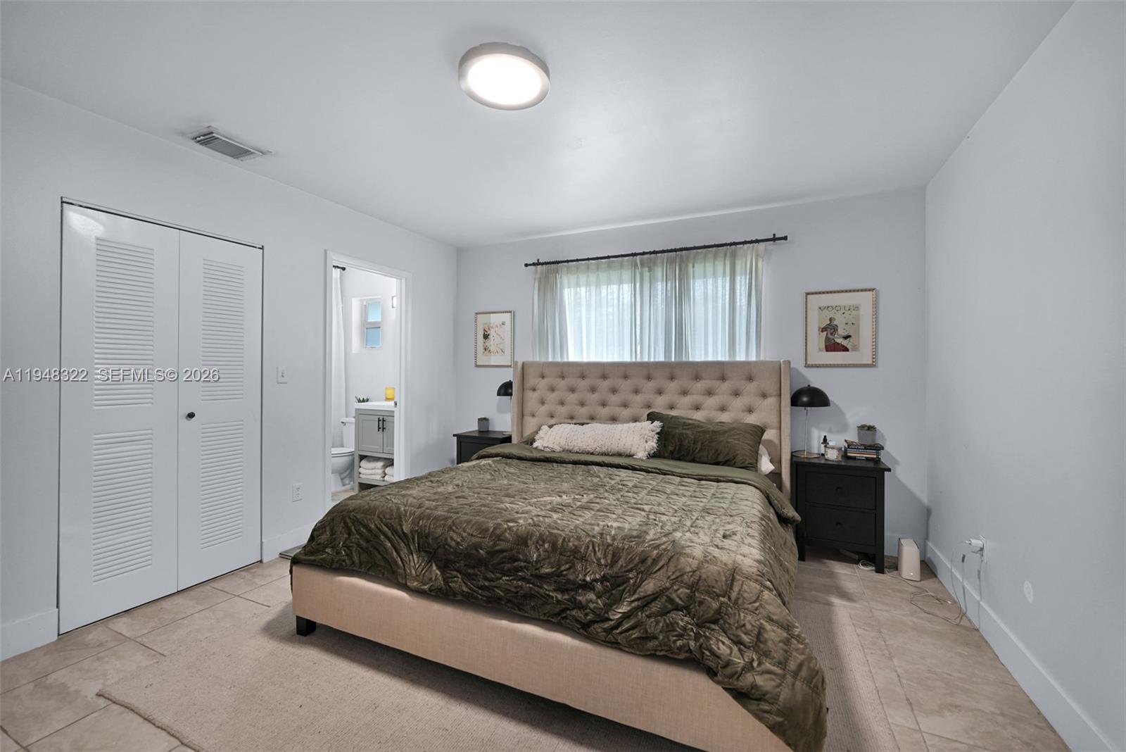 8780 Southwest 200th Terrace Cutler Bay, FL 33189 - Photo 25 of 39 a bedroom with a bed and window