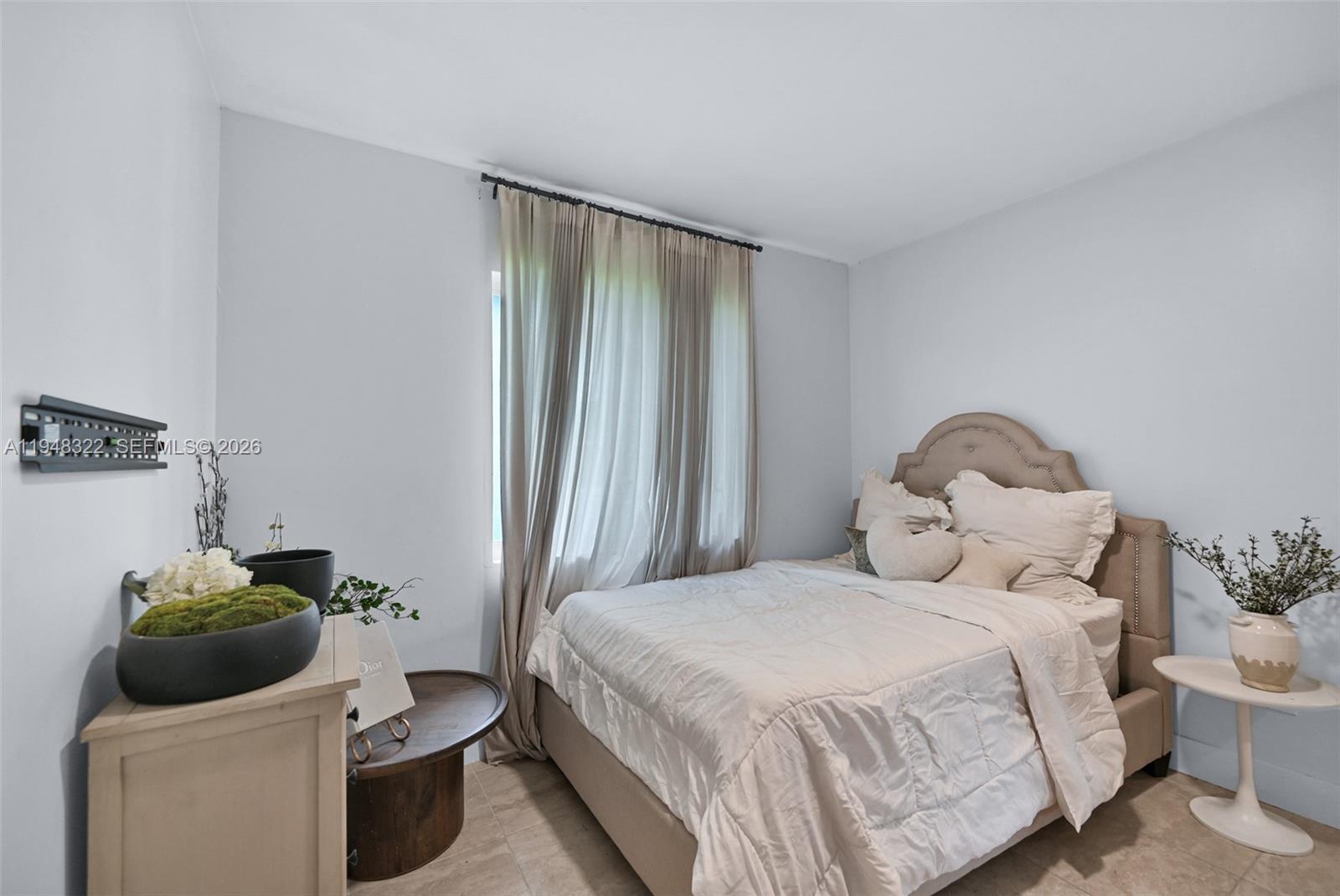 8780 Southwest 200th Terrace Cutler Bay, FL 33189 - Photo 28 of 39 a bedroom with a bed and a window