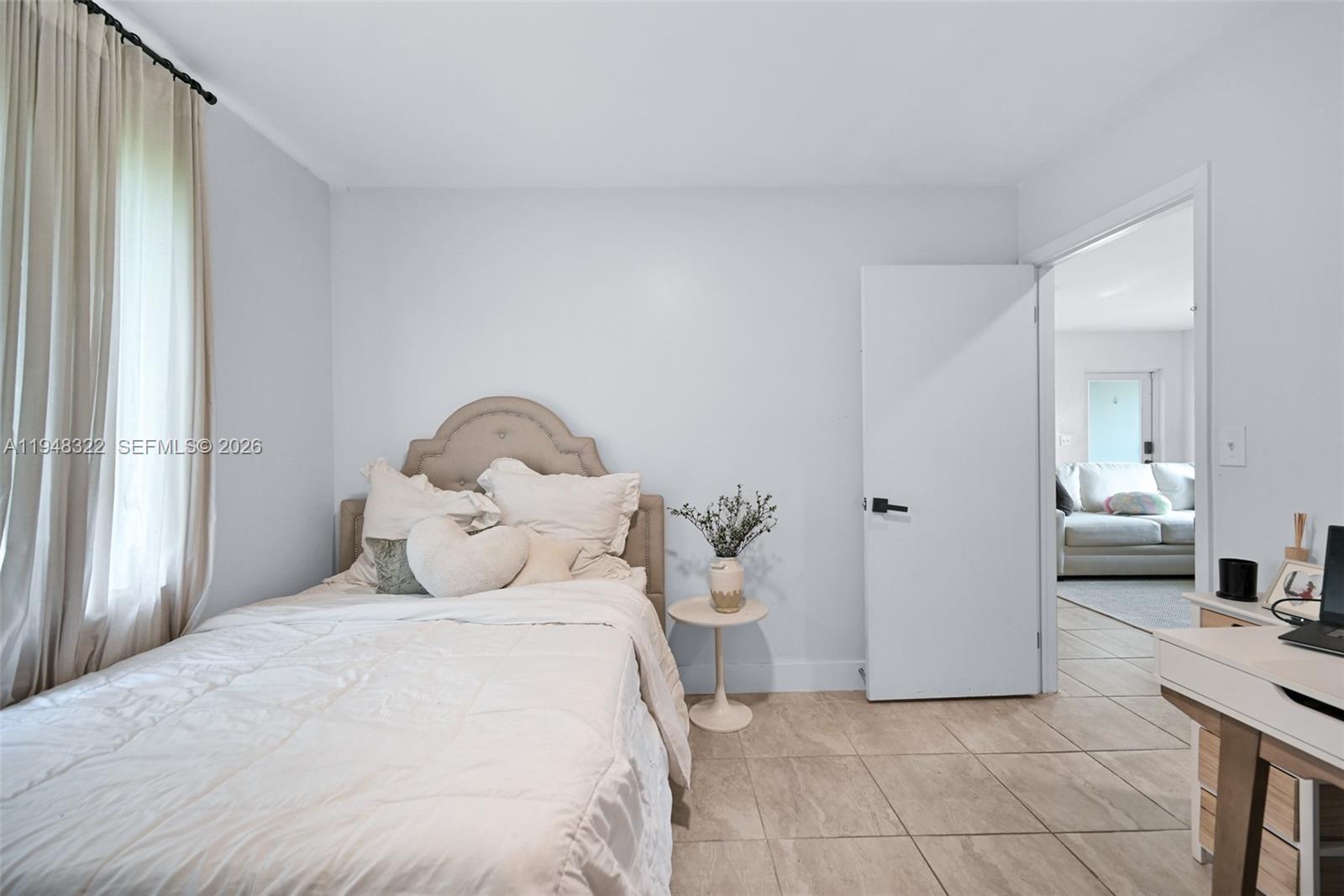 8780 Southwest 200th Terrace Cutler Bay, FL 33189 - Photo 29 of 39 a bedroom with a bed and a mirror