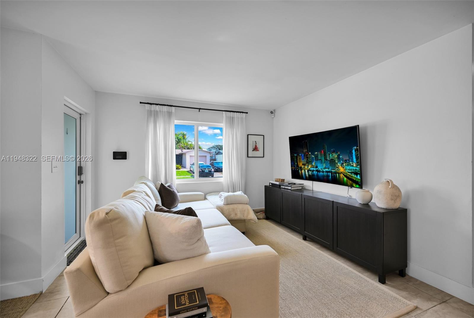 8780 Southwest 200th Terrace Cutler Bay, FL 33189 - Photo 3 of 39 a living room with furniture and a flat screen tv