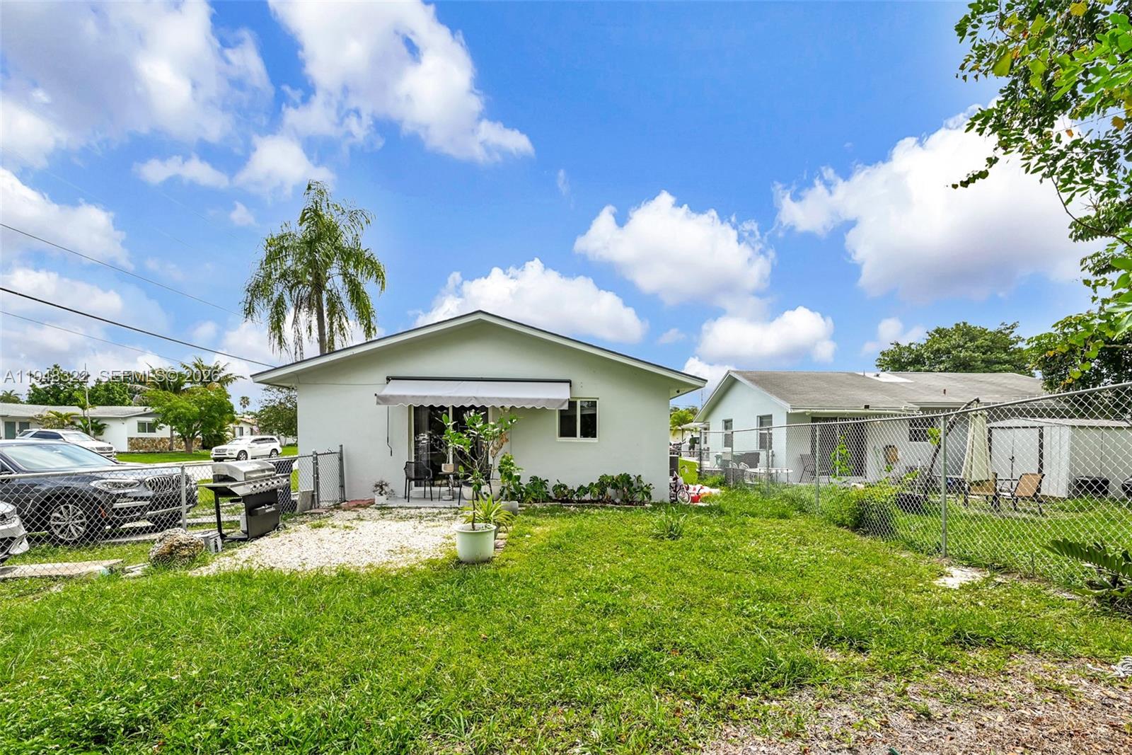 8780 Southwest 200th Terrace Cutler Bay, FL 33189 - Photo 33 of 39 a front view of a house with garden
