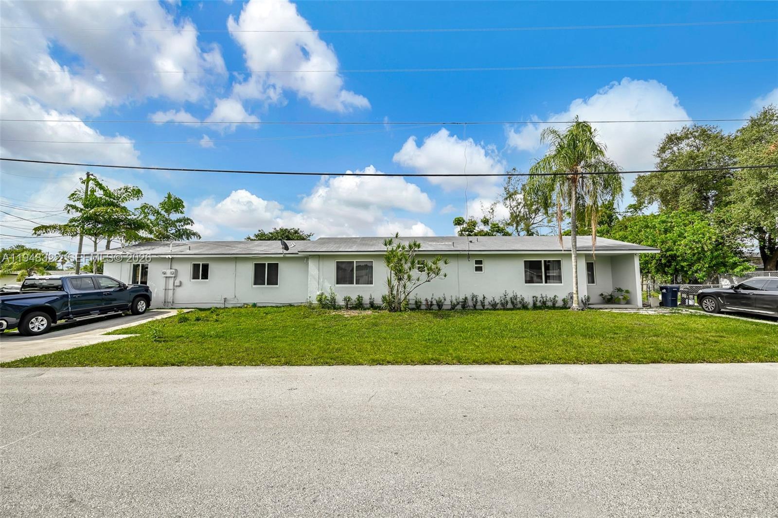8780 Southwest 200th Terrace Cutler Bay, FL 33189 - Photo 35 of 39 a view of a big house next to a yard with big trees