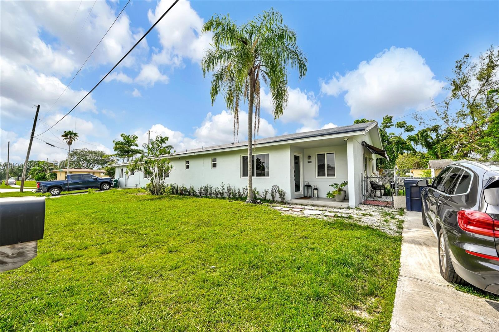8780 Southwest 200th Terrace Cutler Bay, FL 33189 - Photo 36 of 39 a front view of house with yard and outdoor seating