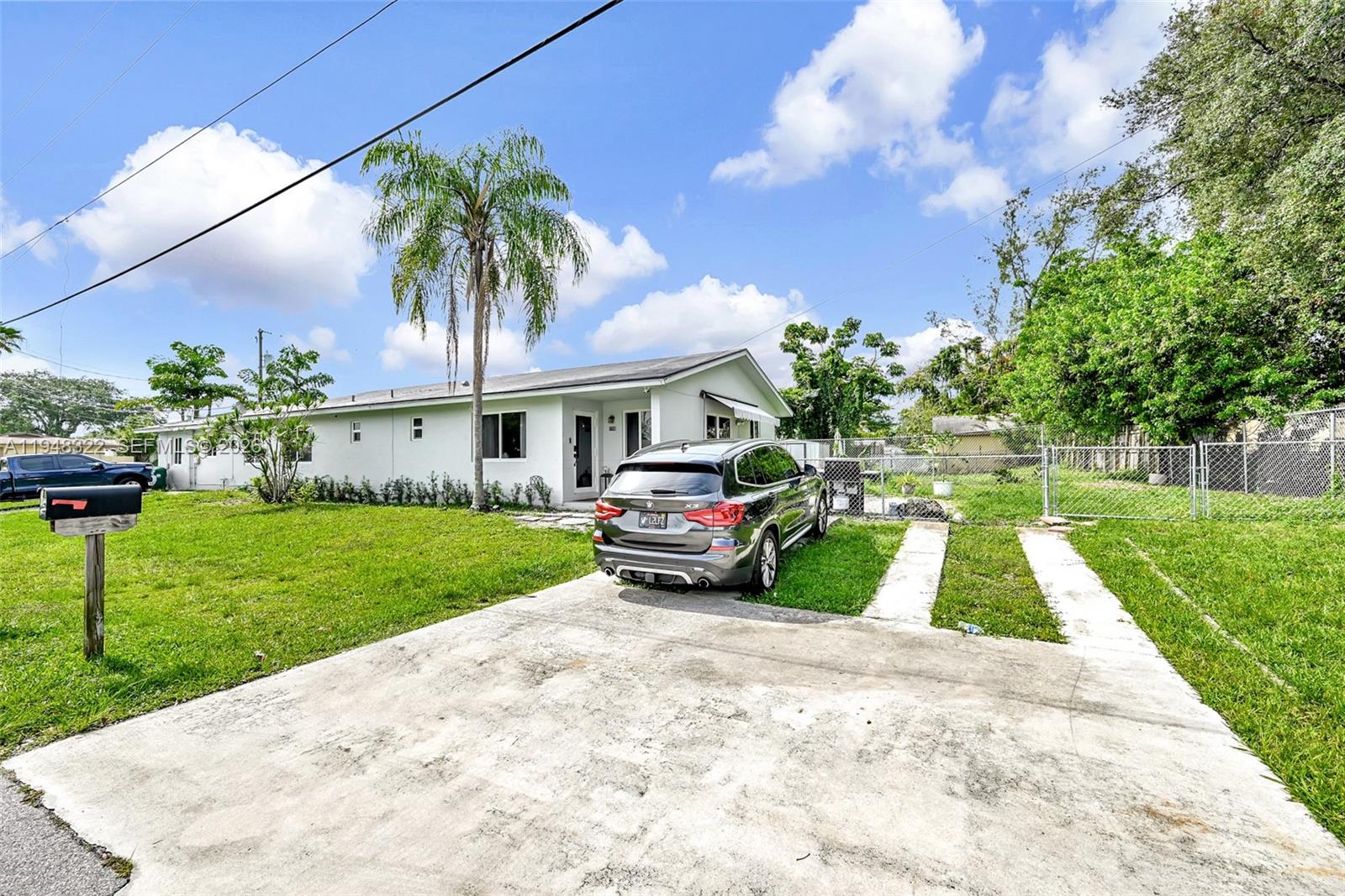 8780 Southwest 200th Terrace Cutler Bay, FL 33189 - Photo 37 of 39 a front view of a house with garden