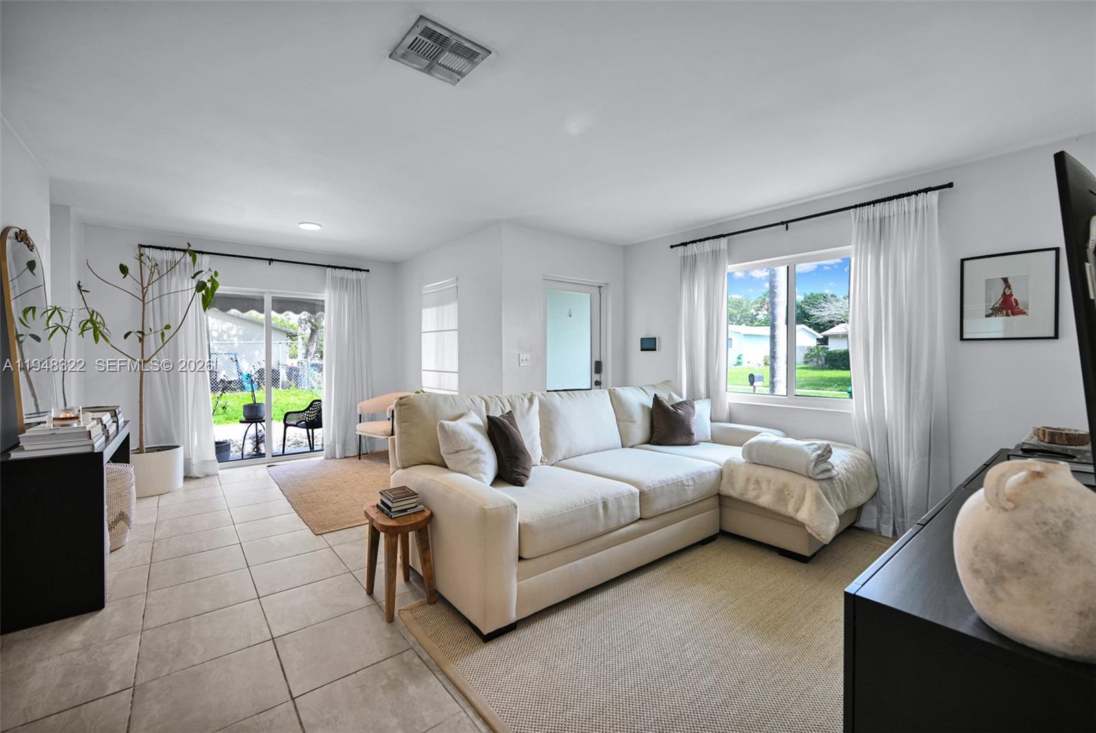 8780 Southwest 200th Terrace Cutler Bay, FL 33189 - Photo 4 of 39 a living room with furniture and a window