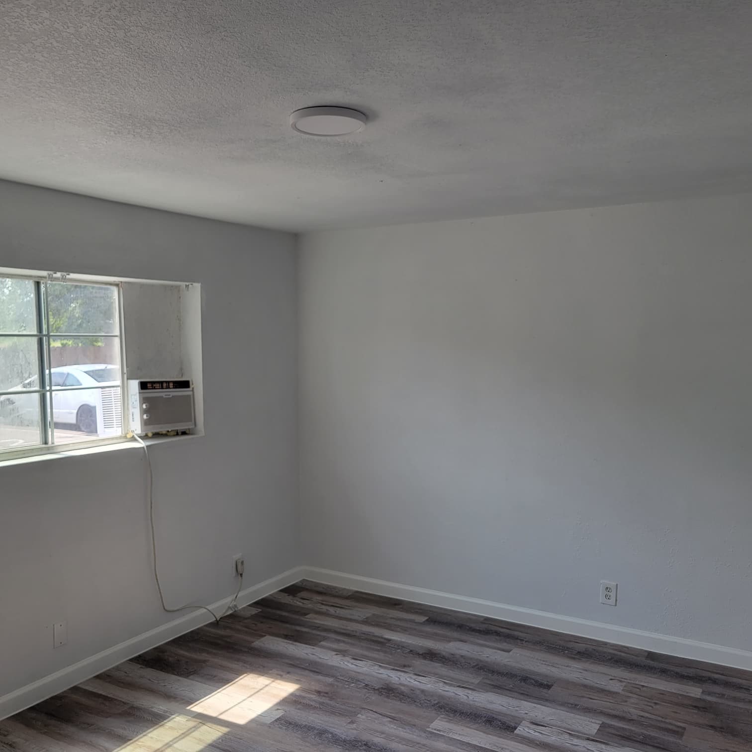 8605 Meta Street, Unit A Houston, TX 77022 - Photo 14 of 20 a view of an empty room with wooden floor and a window