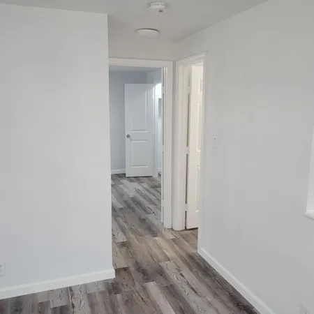 a view of a room with wooden floor