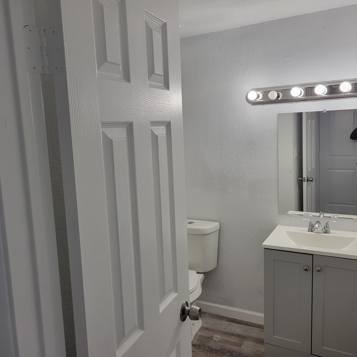 8605 Meta Street, Unit A Houston, TX 77022 - Photo 16 of 20 a bathroom with a toilet a sink and mirror
