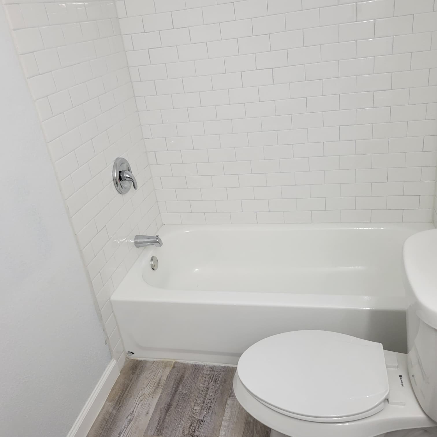 8605 Meta Street, Unit A Houston, TX 77022 - Photo 17 of 20 a white toilet sitting next to a bath tub