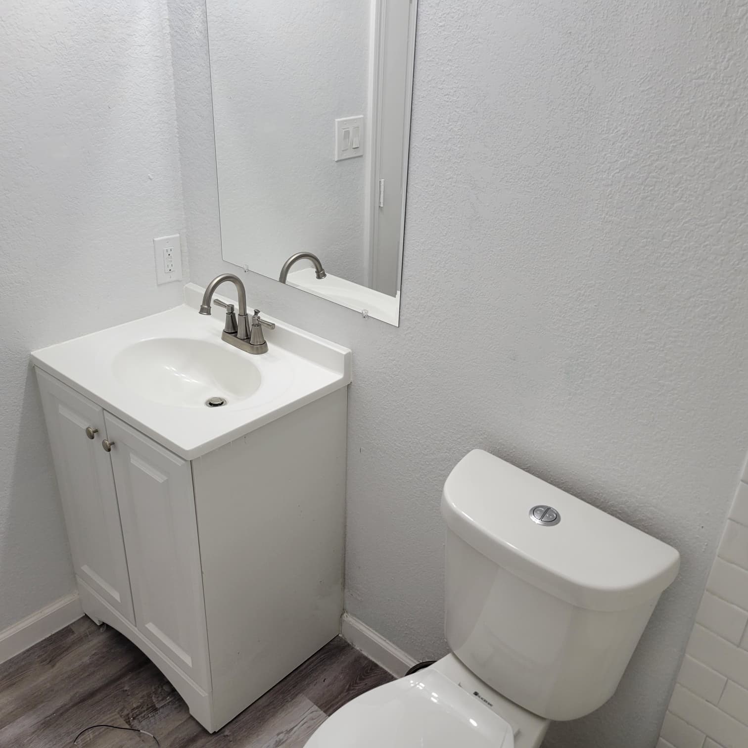 8605 Meta Street, Unit A Houston, TX 77022 - Photo 18 of 20 a bathroom with a toilet a sink and mirror