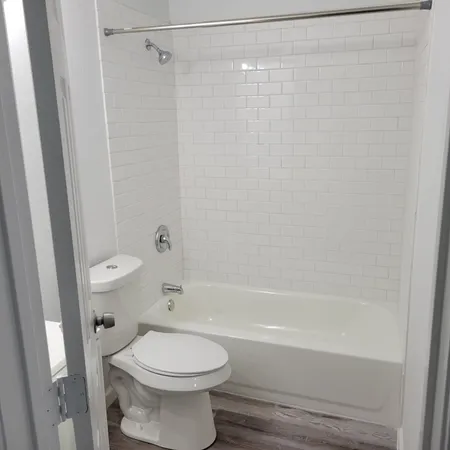 a bathroom with a toilet and shower