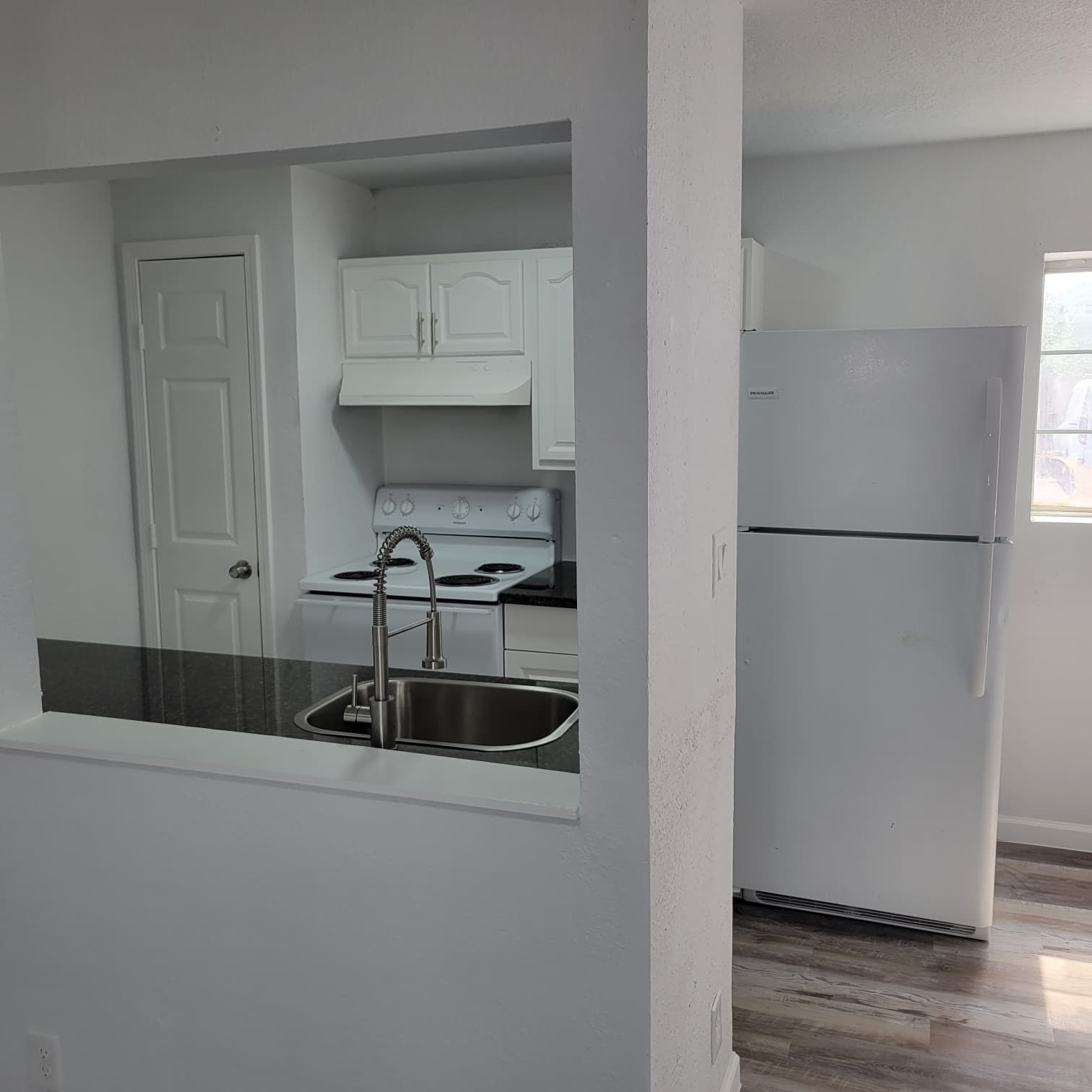 8605 Meta Street, Unit A Houston, TX 77022 - Photo 7 of 20 a kitchen with a refrigerator and a sink