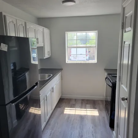 a kitchen with a refrigerator and a sink