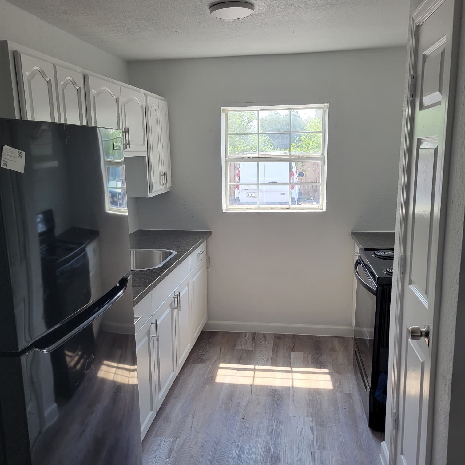 8605 Meta Street, Unit A Houston, TX 77022 - Photo 8 of 20 a kitchen with a refrigerator and a sink