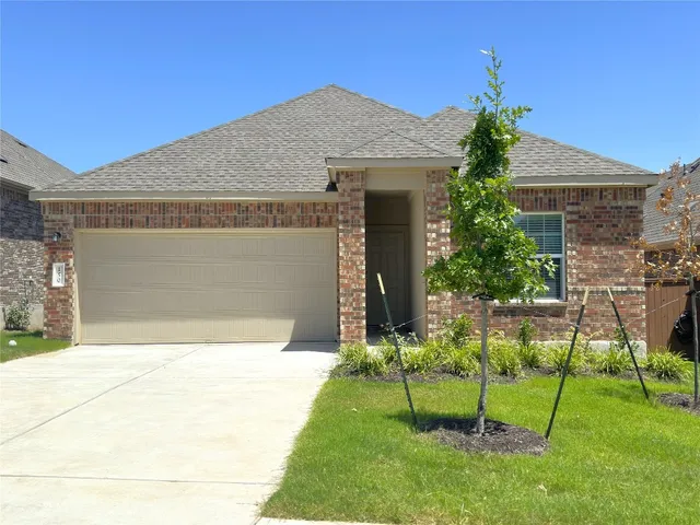 a front view of house with a garden