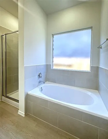 a bathroom with a bathtub and a shower