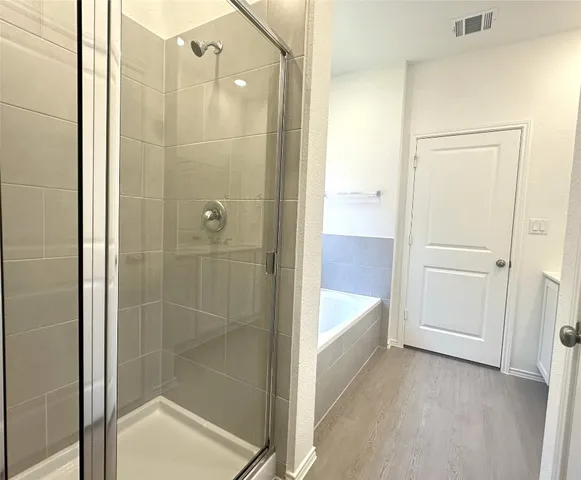 a bathroom with a bathtub and shower