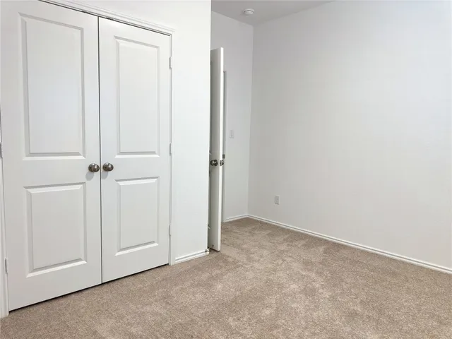an empty room with closet area