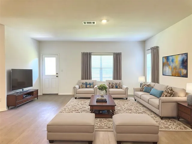 a living room with furniture and a flat screen tv