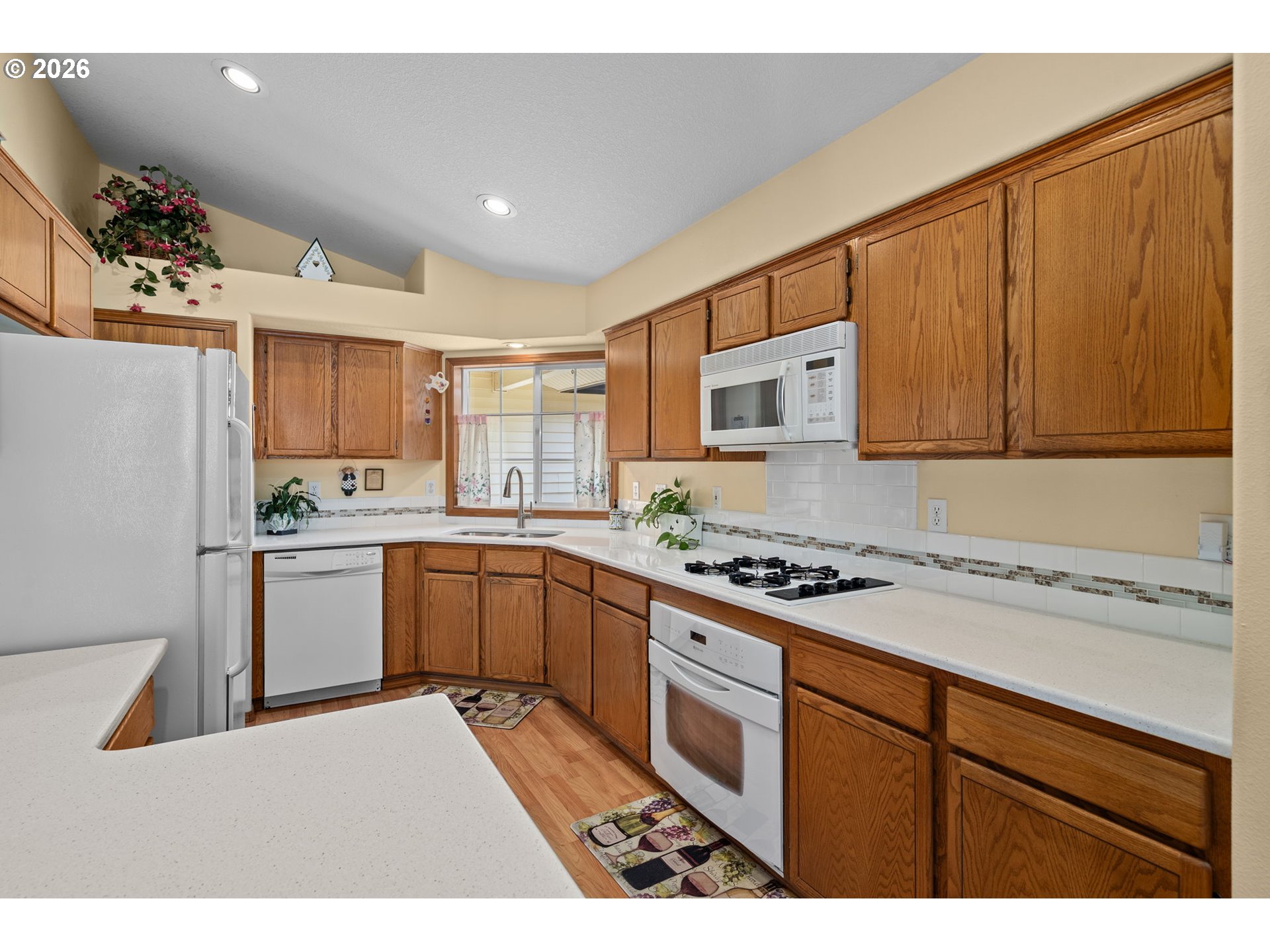 3081 Southwest 31st Street Gresham, OR 97080 - Photo 26 of 38 a kitchen with a stove a sink and a microwave