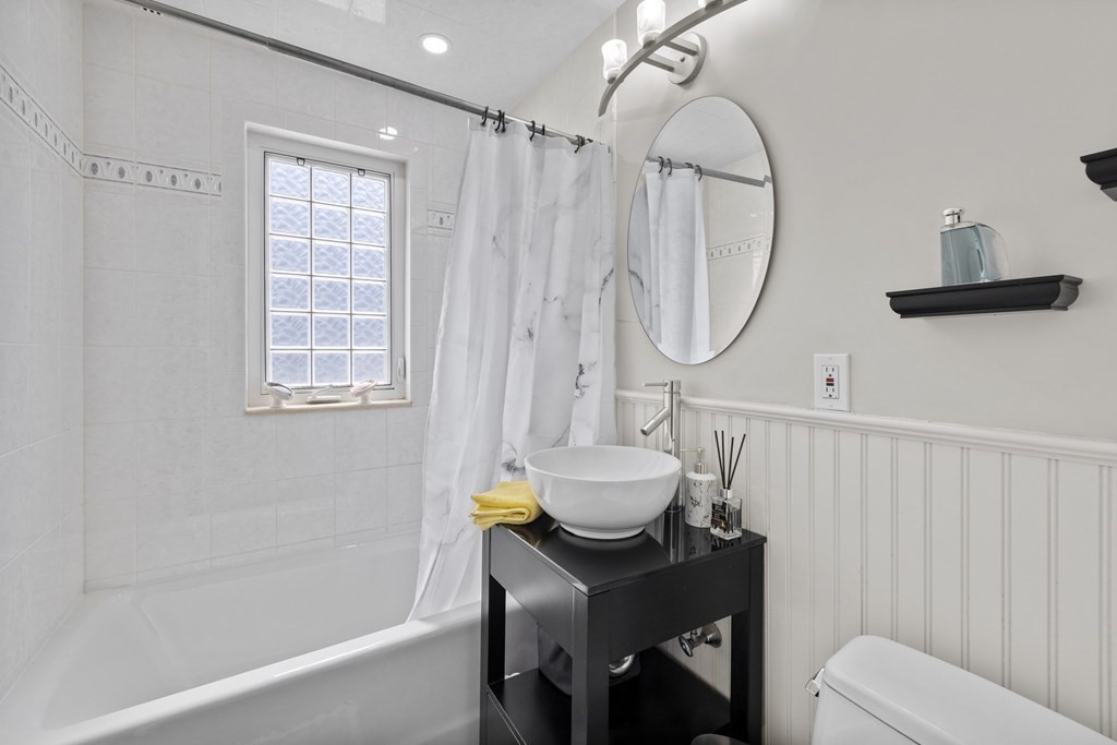 15 Dee Road Lexington, MA 02420 - Photo 21 of 34 a bathroom with a sink toilet and a bathtub