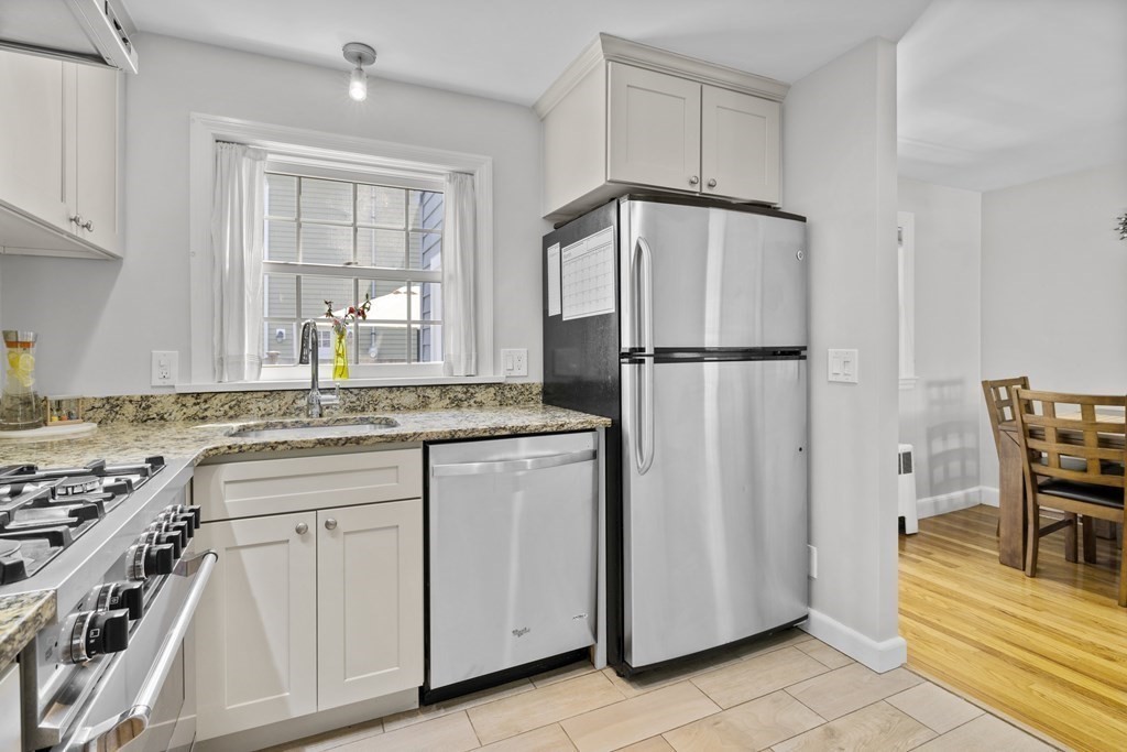15 Dee Road Lexington, MA 02420 - Photo 3 of 34 a kitchen with white cabinets and white appliances