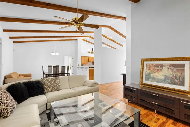 a living room with furniture and a painting on the wall