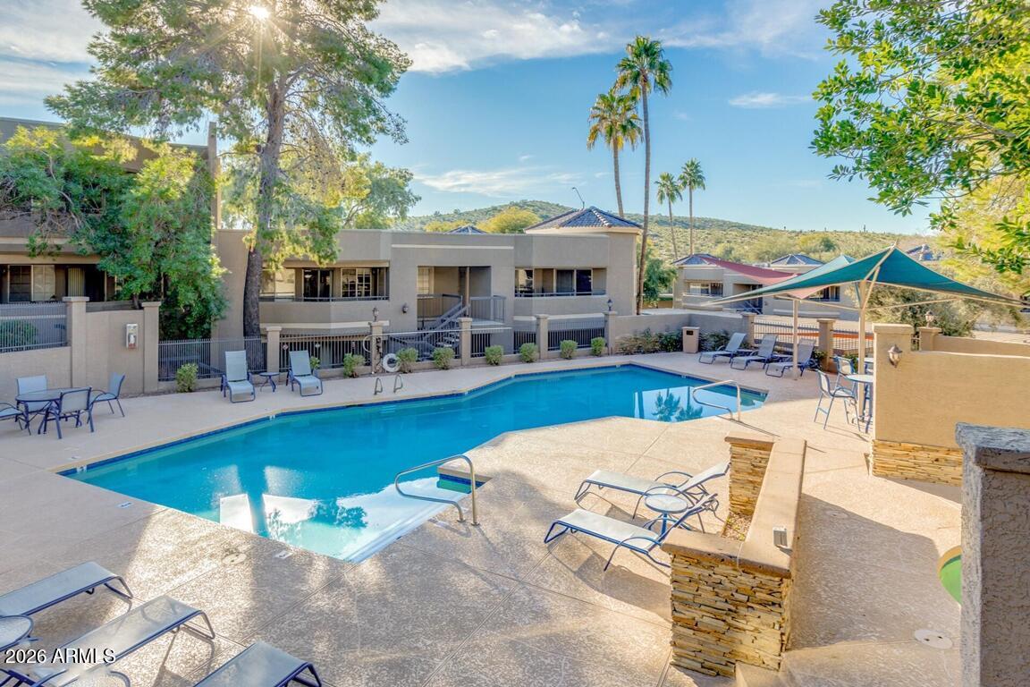 1720 East Thunderbird Road, Unit 2095 Phoenix, AZ 85022 - Photo 17 of 22 a view of a patio with swimming pool table and chairs