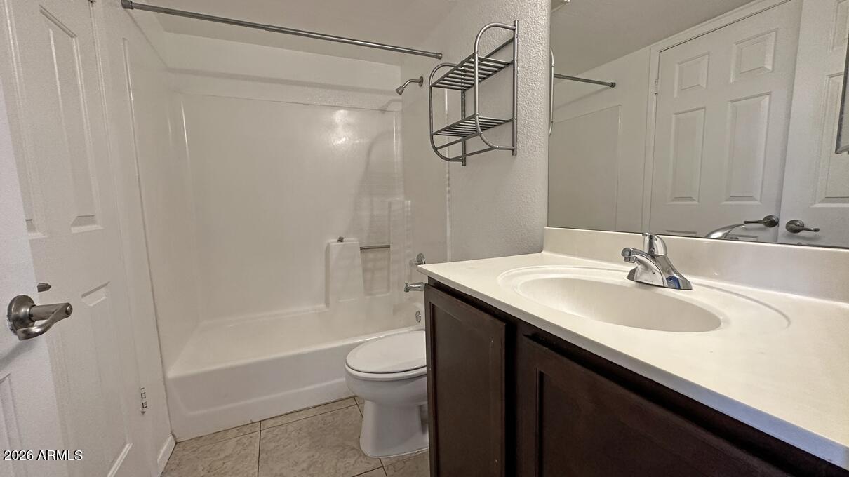 1720 East Thunderbird Road, Unit 2095 Phoenix, AZ 85022 - Photo 3 of 22 a bathroom with a granite countertop sink a toilet and shower