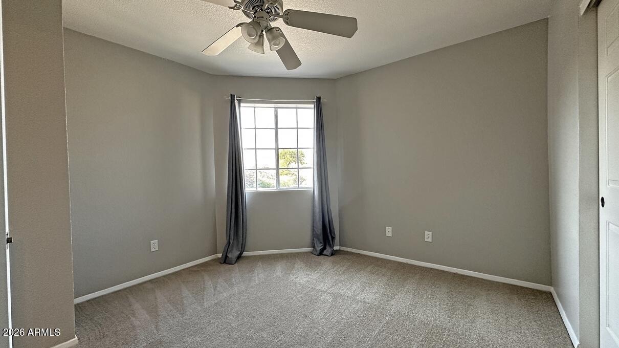 1720 East Thunderbird Road, Unit 2095 Phoenix, AZ 85022 - Photo 5 of 22 an empty room with windows and fan